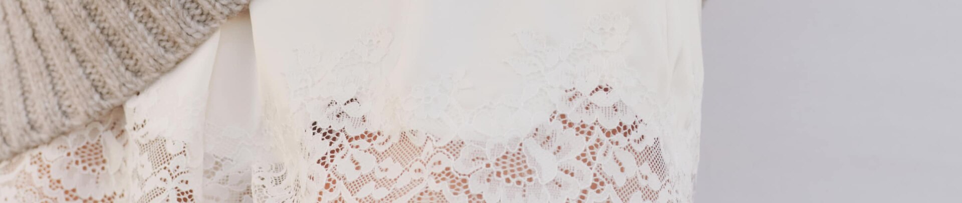 Model is wearing white lace trim satin shorts.