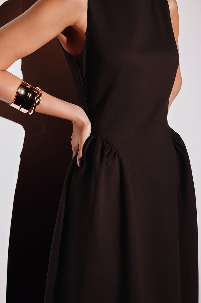 Model is wearing a brown ponte maxi dress.