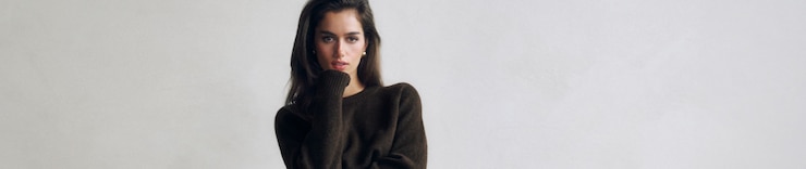 Model is wearing a brown sweater.