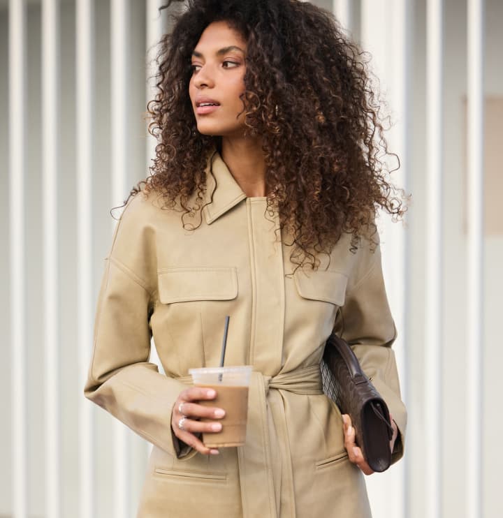  Model is wearing a beige utility jacket.