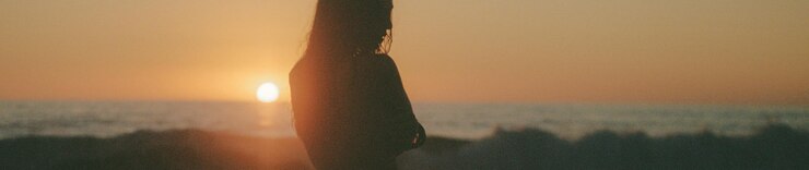 Model is wearing a brown and white printed top and skirt set.
