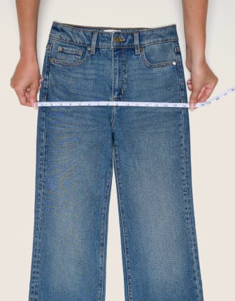 Place the measuring tape on the hips of a pair of jeans.
