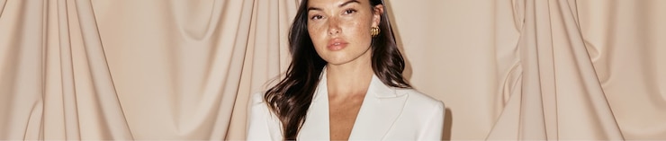 Model is wearing a white blazer dress.