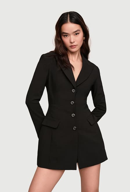 Model is wearing a black blazer romper mini dress.